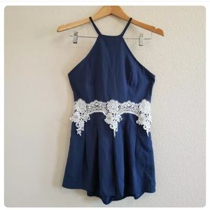 Navy romper with open sides and lace midriff